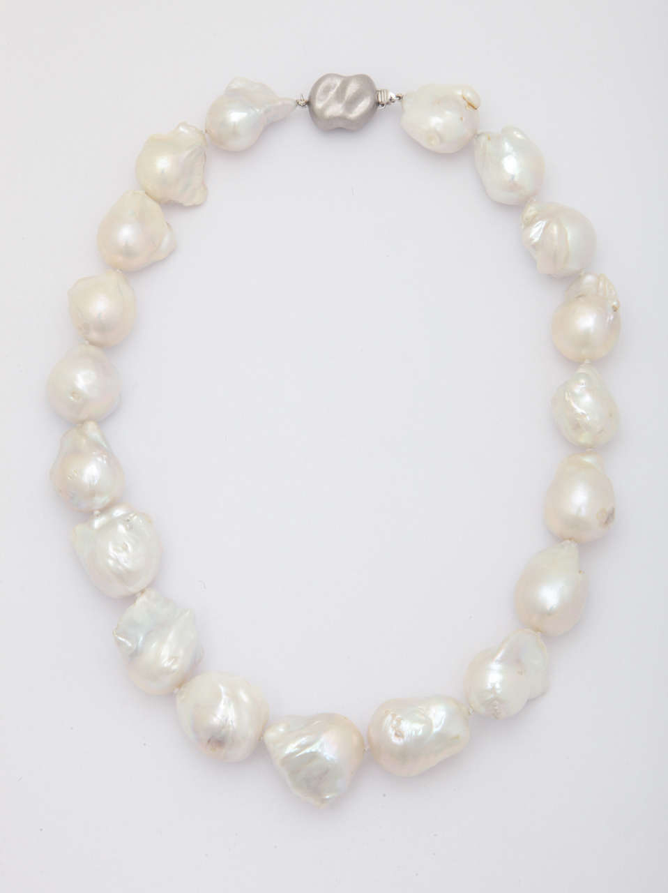 A very impressive pearl necklace consisting of 19 large fresh water baroque pearls 18 x 21 mm in size. The free form shaped clasp is 18 kt white gold. The total length is approximately 18 in. long. Casual enough for day wear and spectacular enough