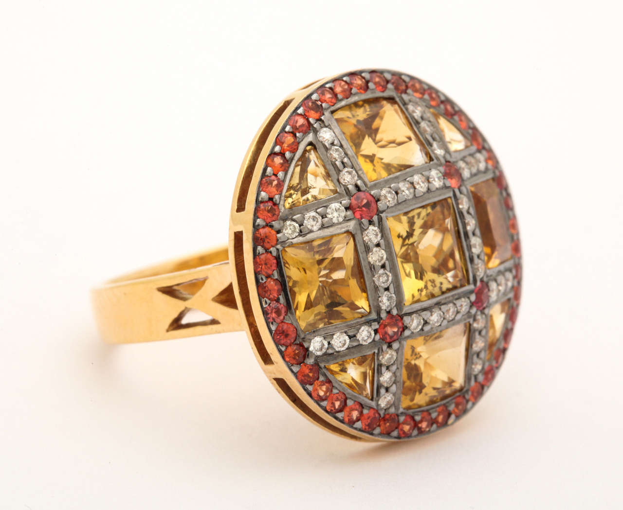 Stunning 18 kt orange gold ring with French cut citrine squares set in a lattice of white dia and red sapphires.. The diameter of the ring is approximately 7/8 in. The red sapphires are African and a sparkly gorgeous red- orange color to compliment