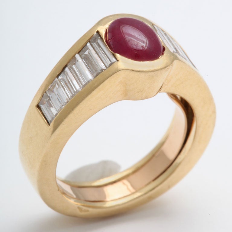 Chic Ruby & Diamond Pinky Ring.  Heavy mounting with squared profile set with rich Oval Cabochon Ruby & complemented by 6 ultra white & clean Diamond Baguettes on either side.  Has removable inner gold guard.  Size 4 1/2