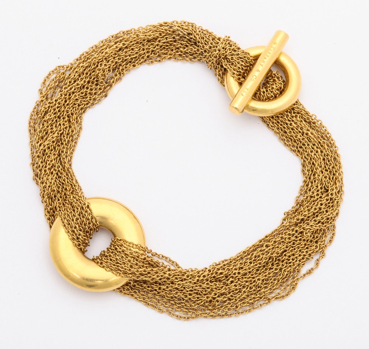 18kt yellow gold bracelet consisting of numerous mesh links designed with a solid gold high polished disc with toggle closure made by TIFFANY &CO.