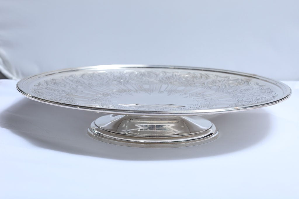 Beautiful, Art Deco, sterling pedestal based serving platter, Tiffany and Co., New York, year-hallmarked for 1923-1924. Approximately 12 1/2 inches in diameter x 2 1/4 inches high. Weighs approximately 38.140 Troy ounces. Beautiful etched pattern.