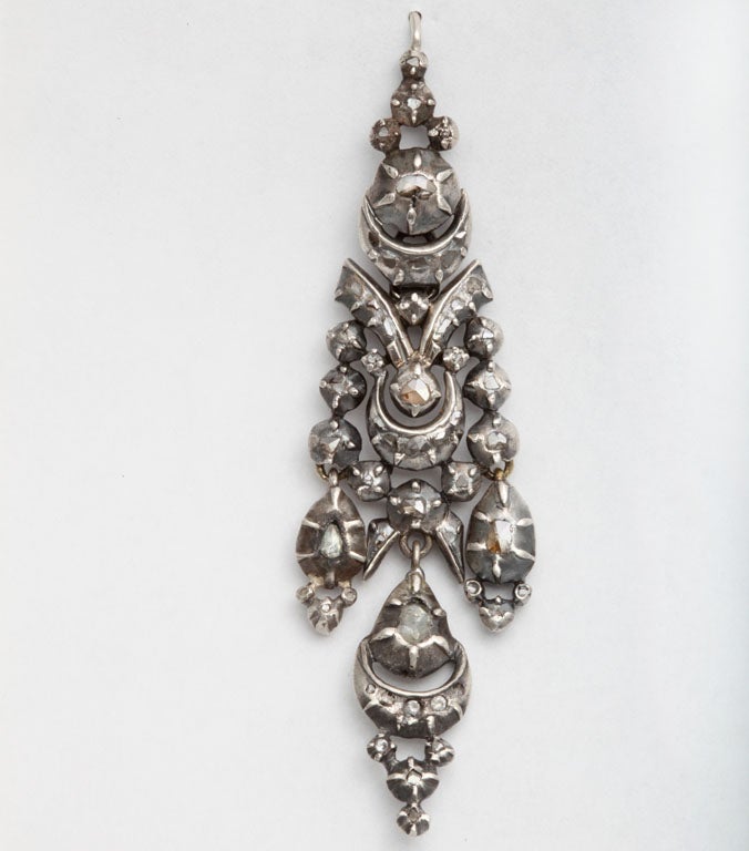 Set in gold and silver, rivers and crescents with antique foiled diamonds in the cascades of these graceful chandelier earrings from 1790 . These are diamonds you can wear for breakfast. The form and design are prominent with well matched early cut