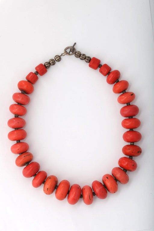 Graduated coral disk bead necklace. Largest disk bead is 1
