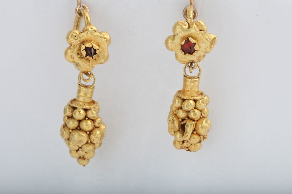 Hand made, bit by bit, a 22kt cluster of grapes made of gold beads, are suspended from gold flowers in these ancient ear pendants with their original fitting for the ear intact.  The ear hook is thick and so a shepherds hook has been attached for