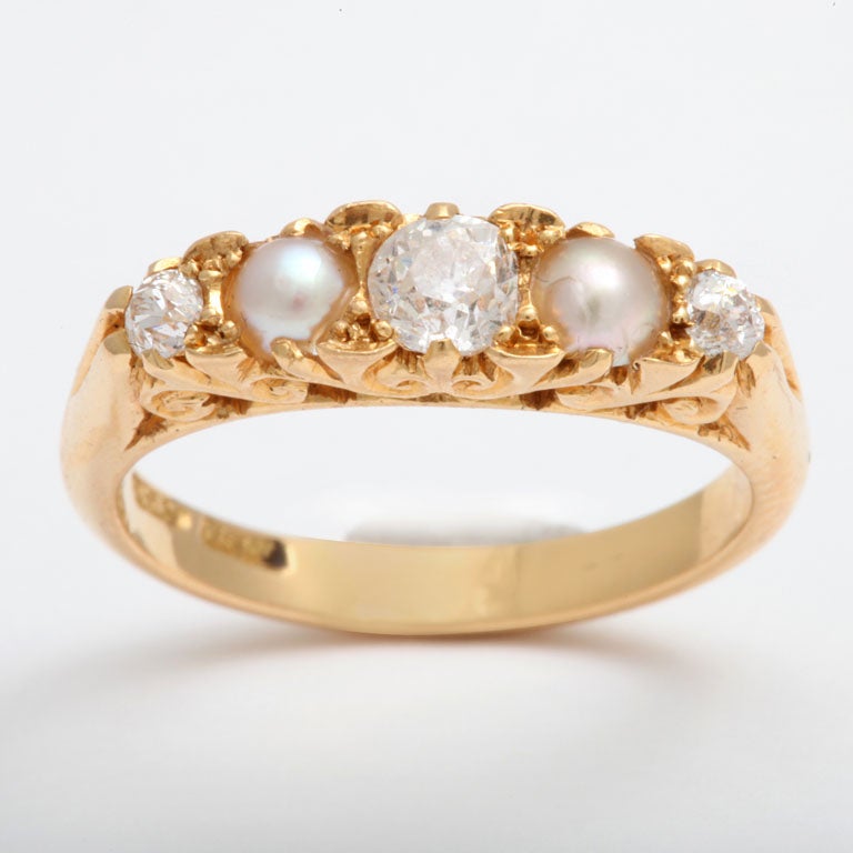 The ring is radiant That is the primary visual effect of the brilliance of the gold and diamonds in this sweet 18kt gold band.  Our digital photo cannot bring the life of the real thing to your view. The whiteness of the center diamond overrides its