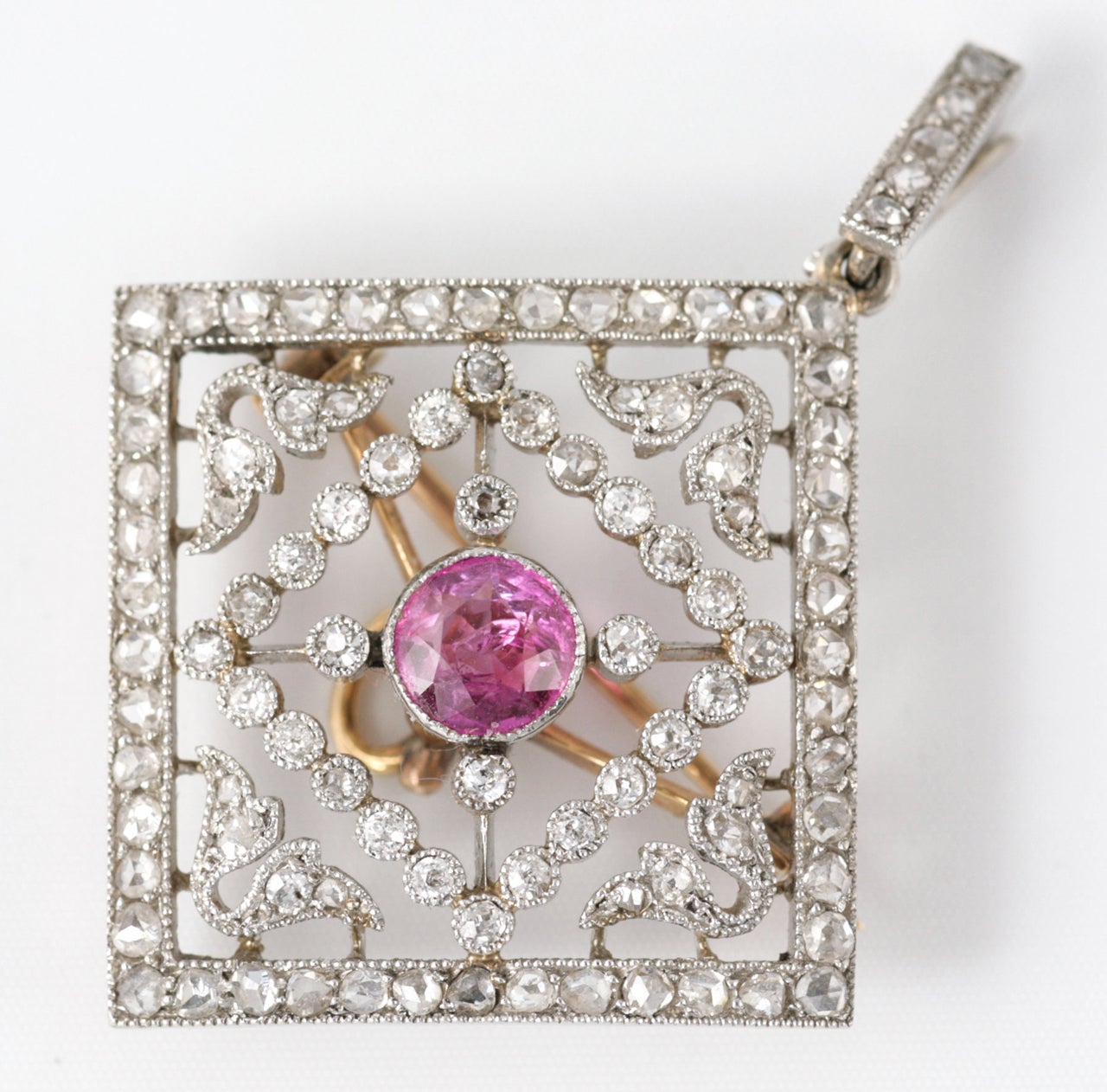 Platinum set Diamond brooch pendant with pink Sapphire centre in origianl fitted case.