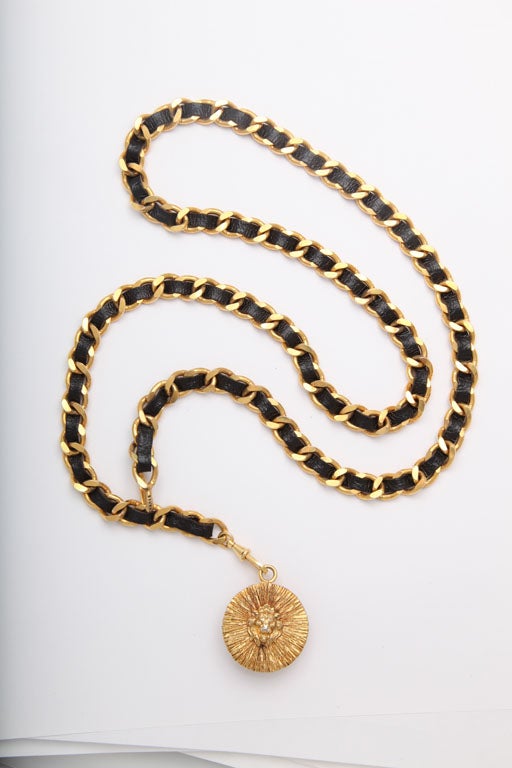 Chanel iconic black and gold chain belt / necklace with lion motif coin.