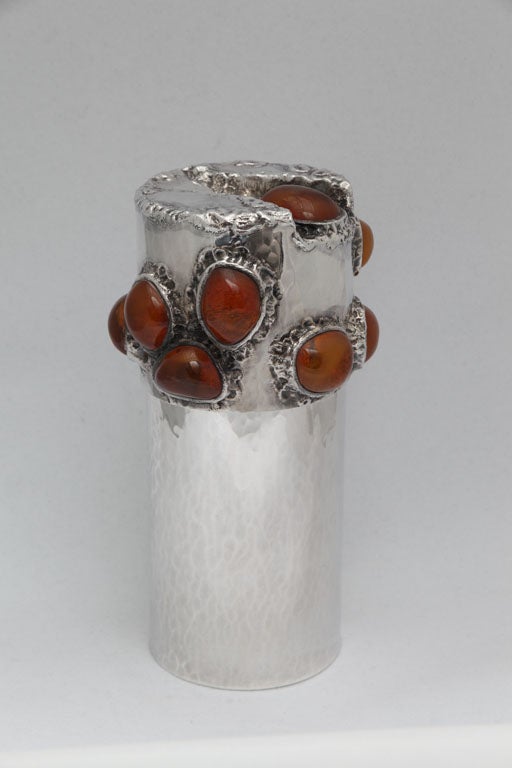 Beautiful things are meant to hold beautiful objects. This canister is tall enough and deep enough to hold all of your special possessions. Large amber stones adorn the lid.