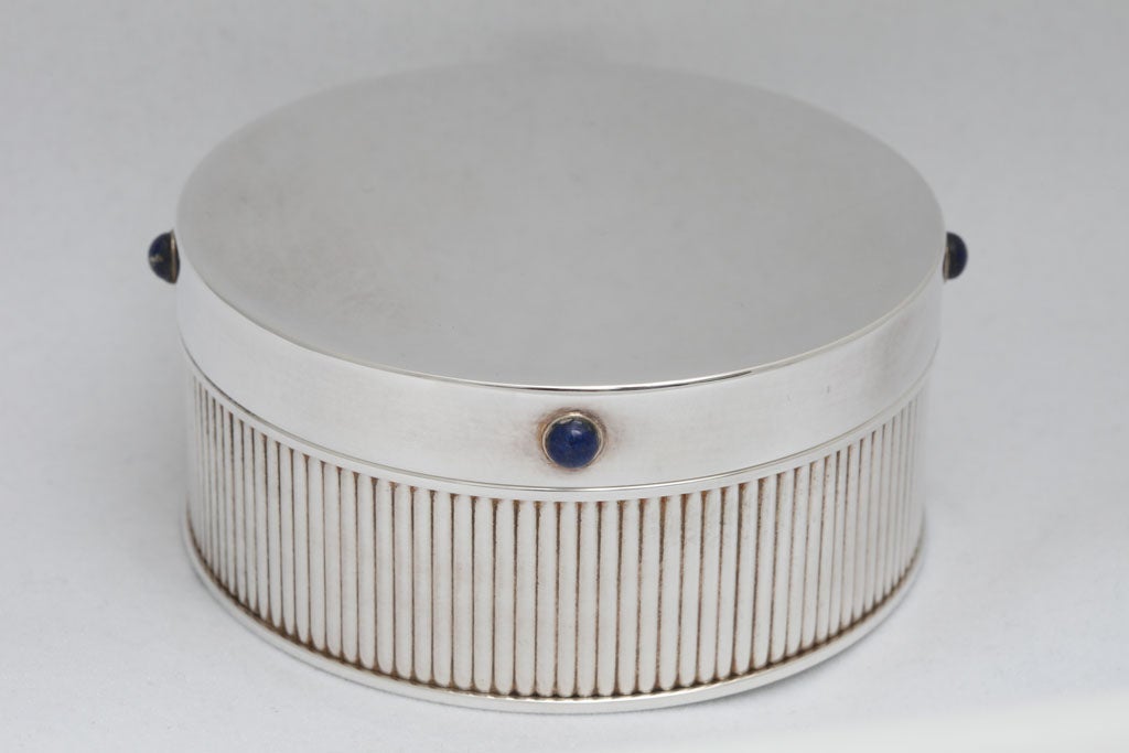 What better place to keep your Cartier jewelry then in an elegant Cartier round silver lidded-box with cabochon- cut lapis lazuli?