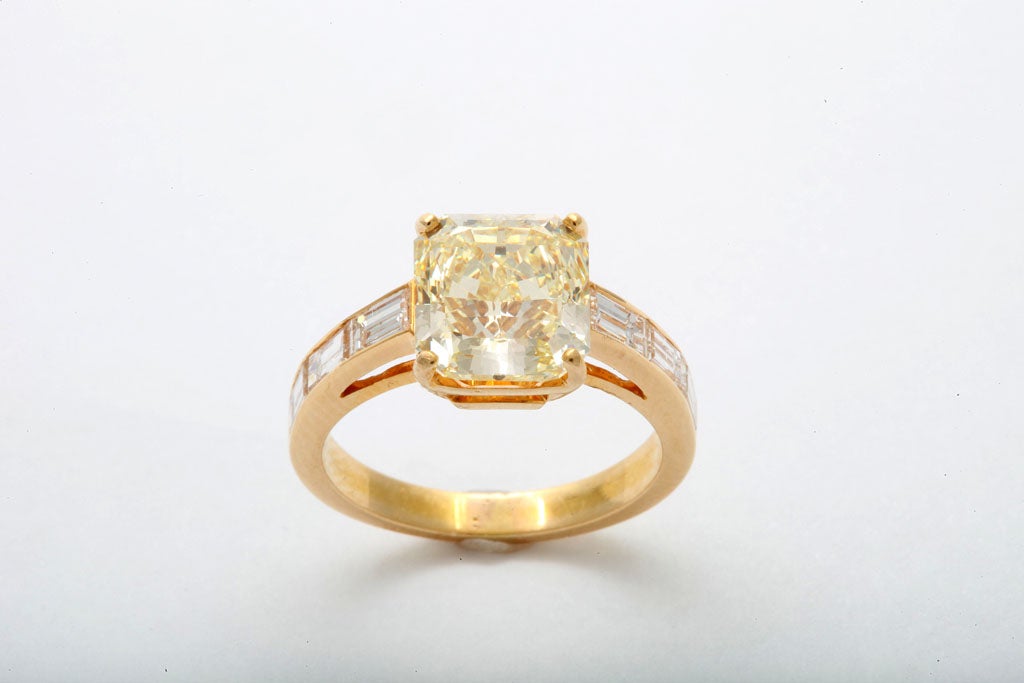 Radiant cut fancy yellow diamond 4.01 carats accompanied by GIA report # 14690952 (Fancy Yellow VS1) Set in Hand made 18k yellow gold mounting set with 6 straight baguette diamonds 1.20 carats