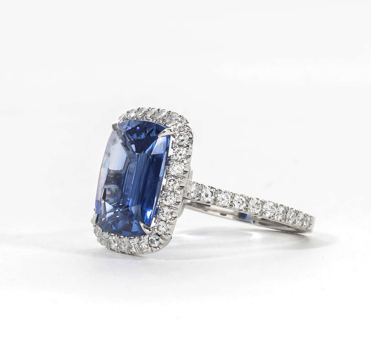 Gorgeous Cushion Cut blue sapphire set in a classic handmade halo mounting.

6.40 carat blue sapphire -- looks like a 10 carat!
1.00 carats of diamonds
Platinum

A beautiful center sapphire set in a wearable design.