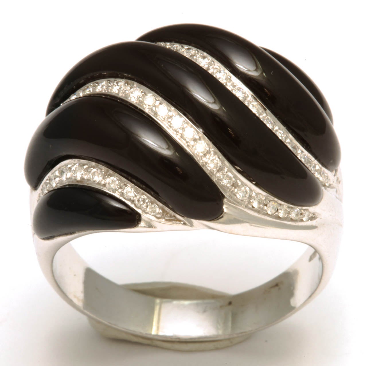 18kt White Gold Swirl ring set in Black Onyx & full cut clean & white Diamonds.  Very chic & imposing.