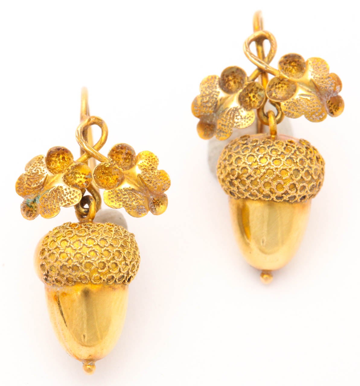 Revered as a symbol of life force and fertility, an offshoot of the mighty oak, here interpreted in the hammered gold leaves, acorn earrings have found their way to our offering for fall. These are light in weight and wearable Victorian earrings.