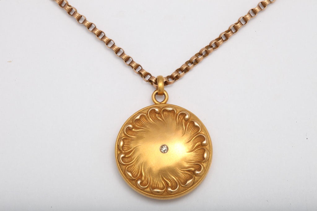 This is a locket that comes to us from the Art Nouveau Movement. Lockets are a favorite piece of jewelry for every day wear.  Enlarge the image to get the full effect of the gold work.  The repousee sunflower engraving is artistic and very