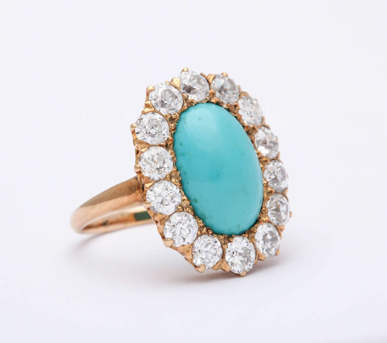 Beautiful Edwardian Persian Turquoise Oval surrounded by 14 very clean & very white old mine Diamonds.  Set in 18kt Yellow Gold.  A true Family Heirloom