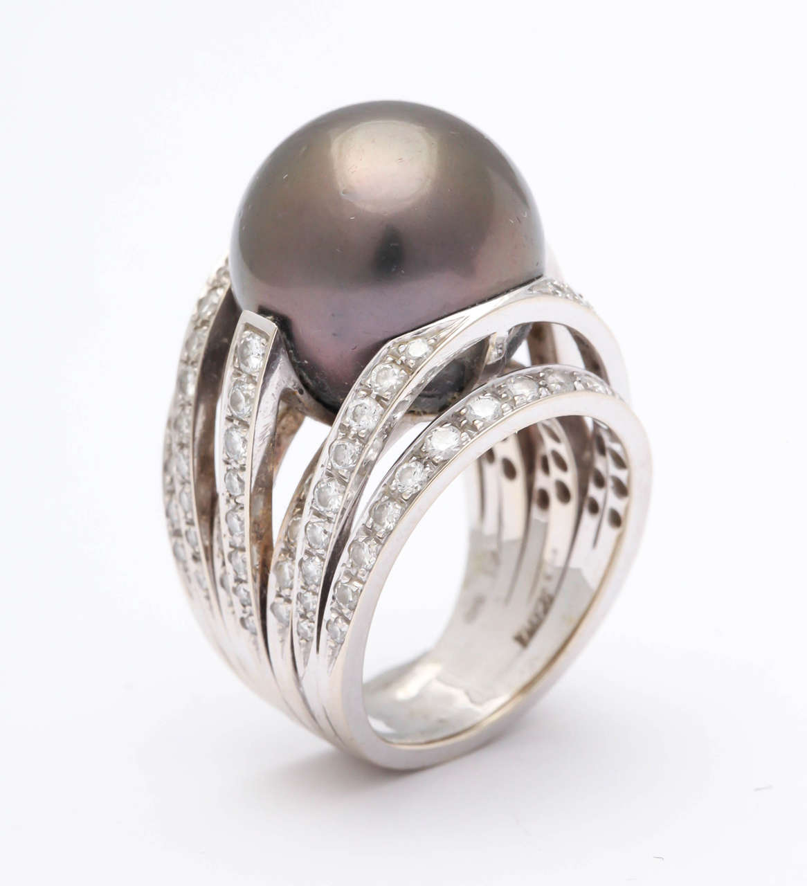 Sumptuous constructed Ring with a 13mm South Sea Pearl Ring floating on a nest of Bands set with clean  cut  & sparkling white Diamonds. Over the top!