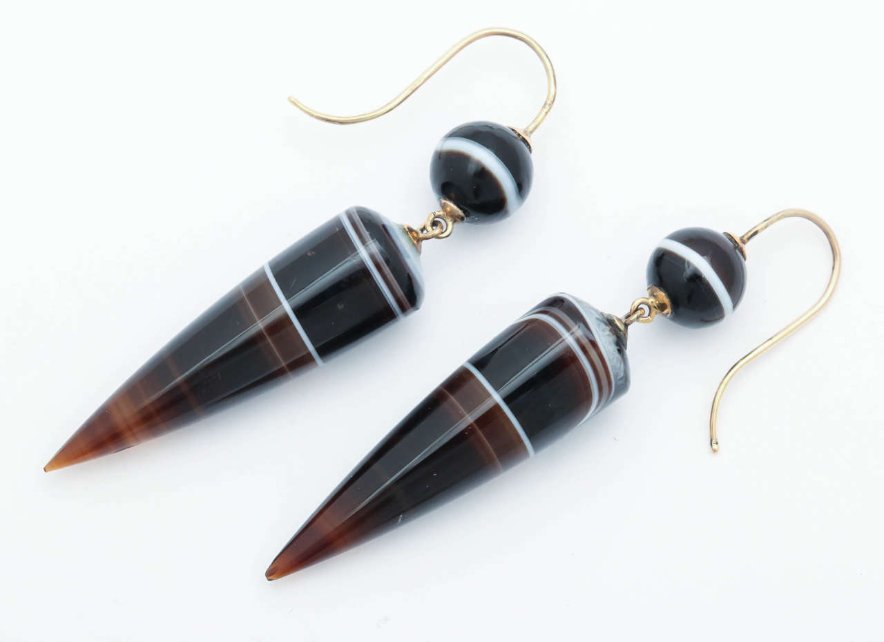 Banded agate is a constant reminder of the wonder of nature, a force to which the Victorians gave much attention and sentiment. In this pair of chandelier earrings, a stone cutter took parts of the agate that had similar patterns then sculpted and