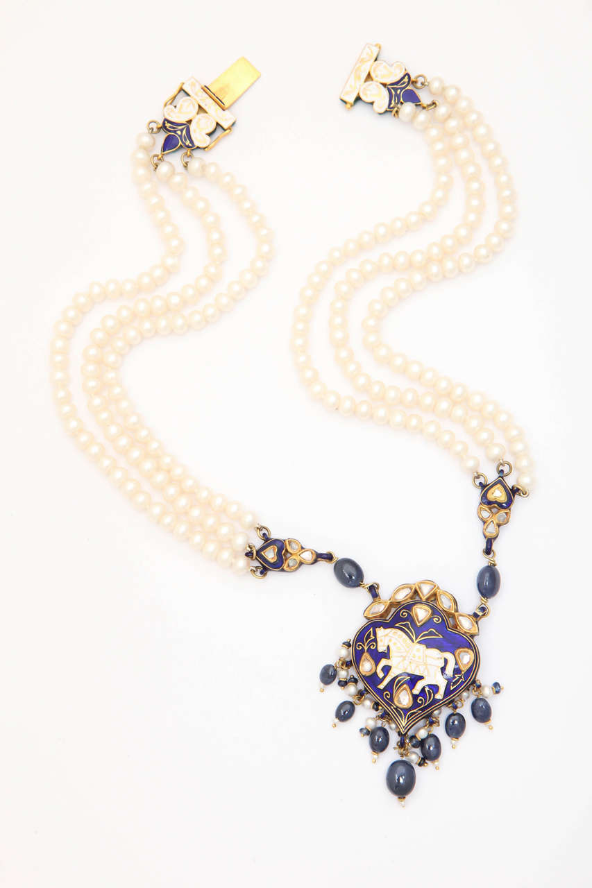 The enameled pieces were made in India. They are enameled front and back as is the style of Kundan jewelry. The central pendant is connected to the fresh water pearls  by oval sapphire beads and an enamel section piece. The diamonds are called