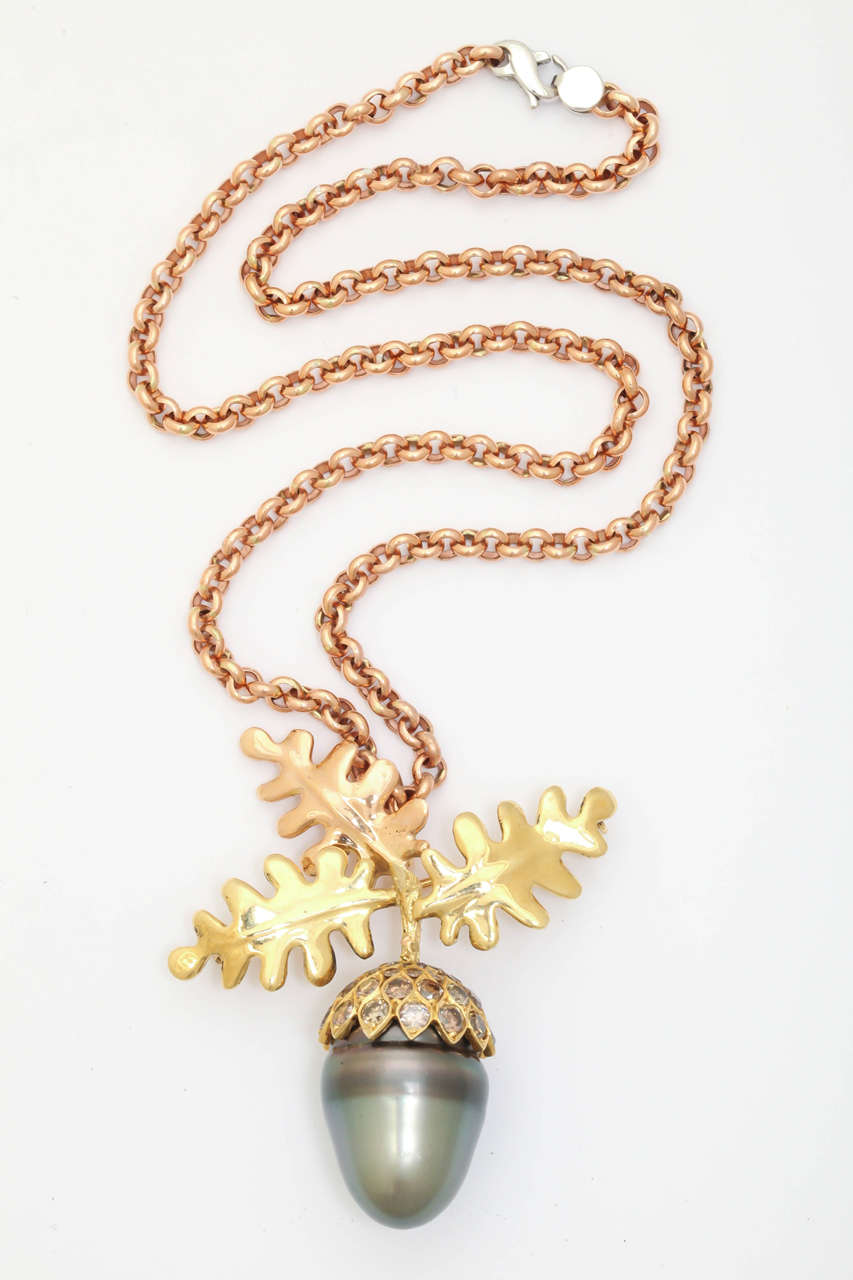Spectacular larger then life size 18kt rose and yellow gold acorn. The center oak leaf is rose gold and the other two are yellow gold. The acorn cap has 7 cts. of diamonds in various natural shades of  brown. The acorn part is a giant baroque