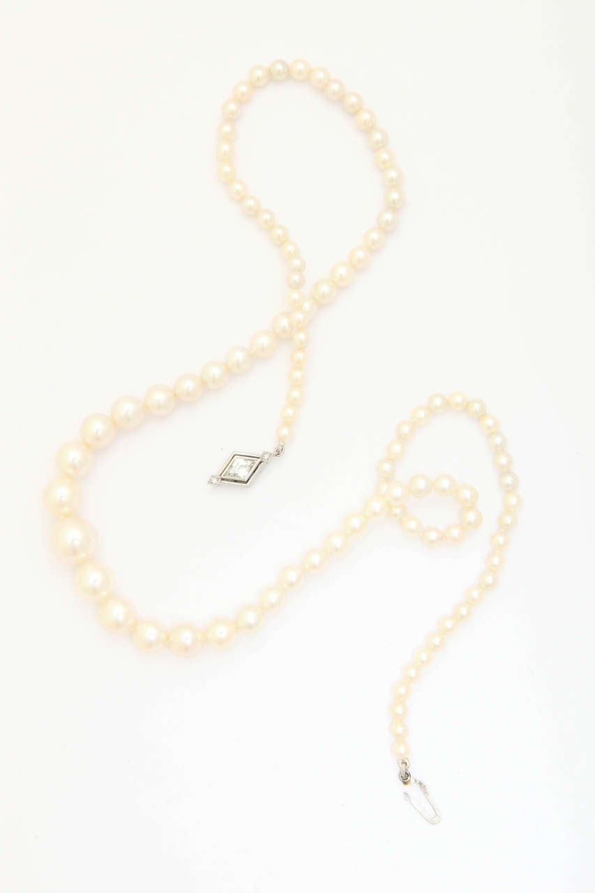 This beautiful vintage (late 40's) cultured pearl necklace has a superb luster as though it's never been worn. There are 96 pearls, with the center pearl being 10 mm graduating to 3-4 mm. Total length is 18 in. The unique clasp is in 14 kt white