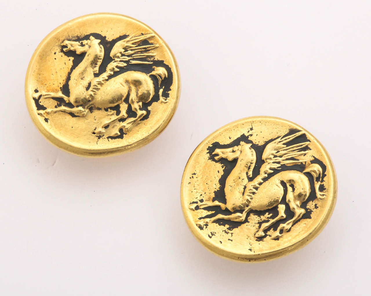 These elegant earrings have the appearance of ancient coins with a carved Pegasus horse in the center. The disks are 3/4 in. in diameter. They are clips but a post can be added at your request.