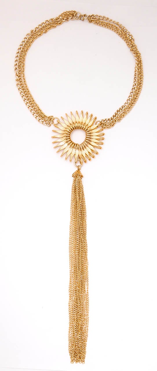 Delicate gold tone German necklace with a sunburst medallion.  Tassel is 8 1/2