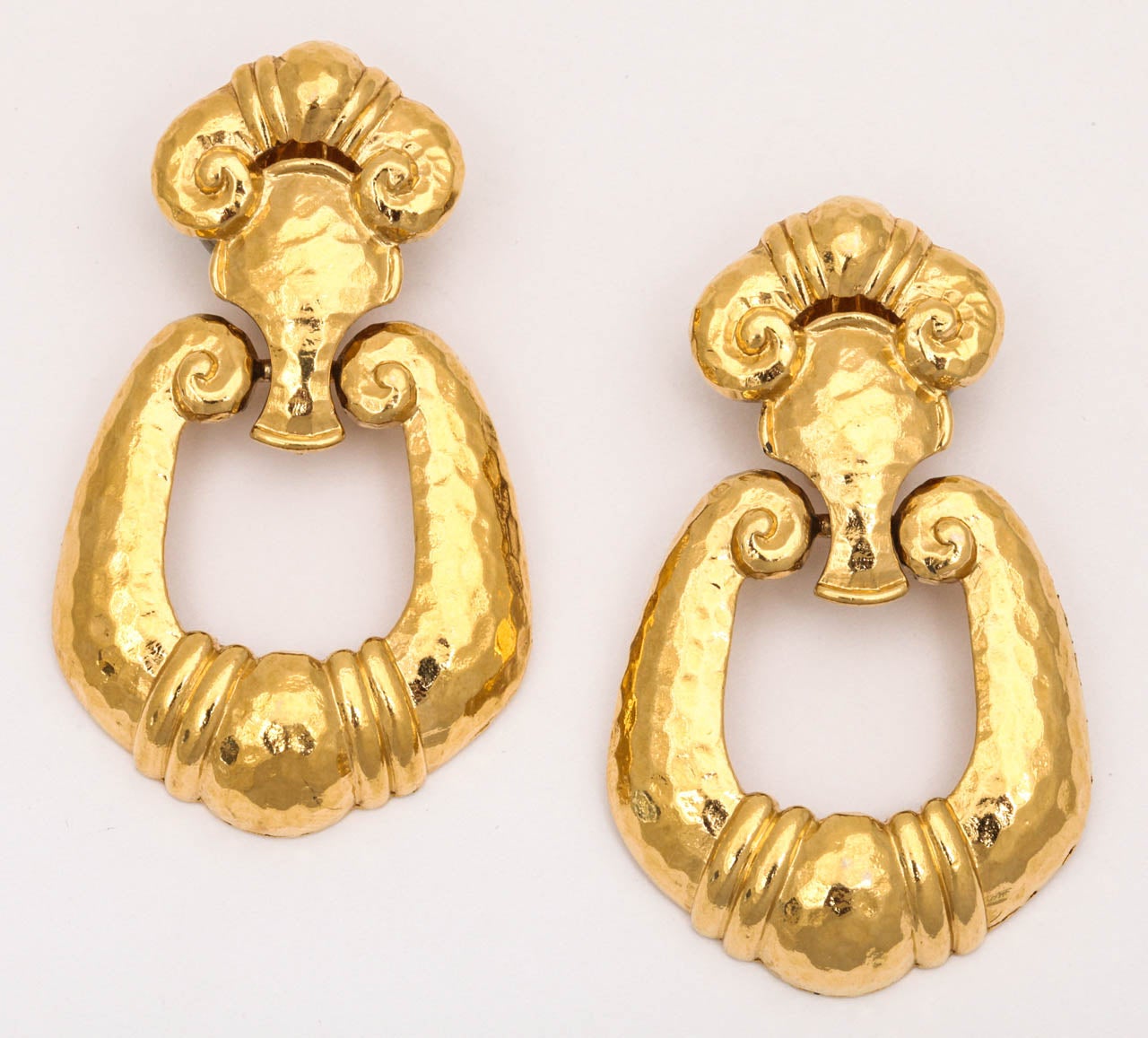 Large hammered gold tone door knocker earrings marked Barrera for Avon.