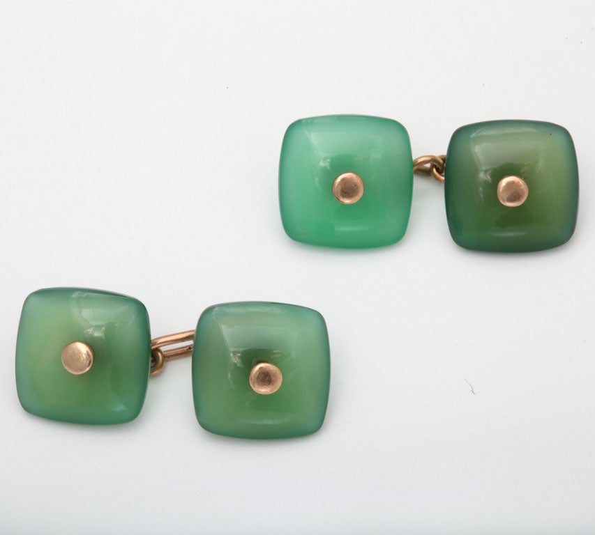 Art Deco 14K gold cufflinks with rounded jade squares connected by gold chains.