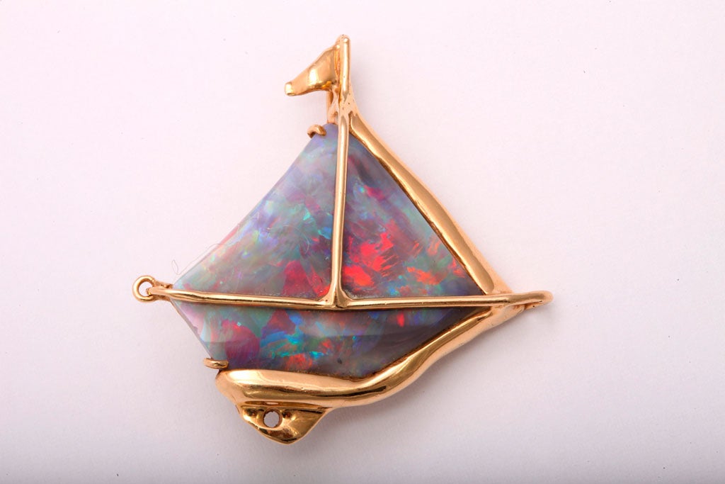 This piece was custom made to showcase this slice of black crystal opal.  It is not a doublet, but the back is used to protect the stone and intensify the color.
