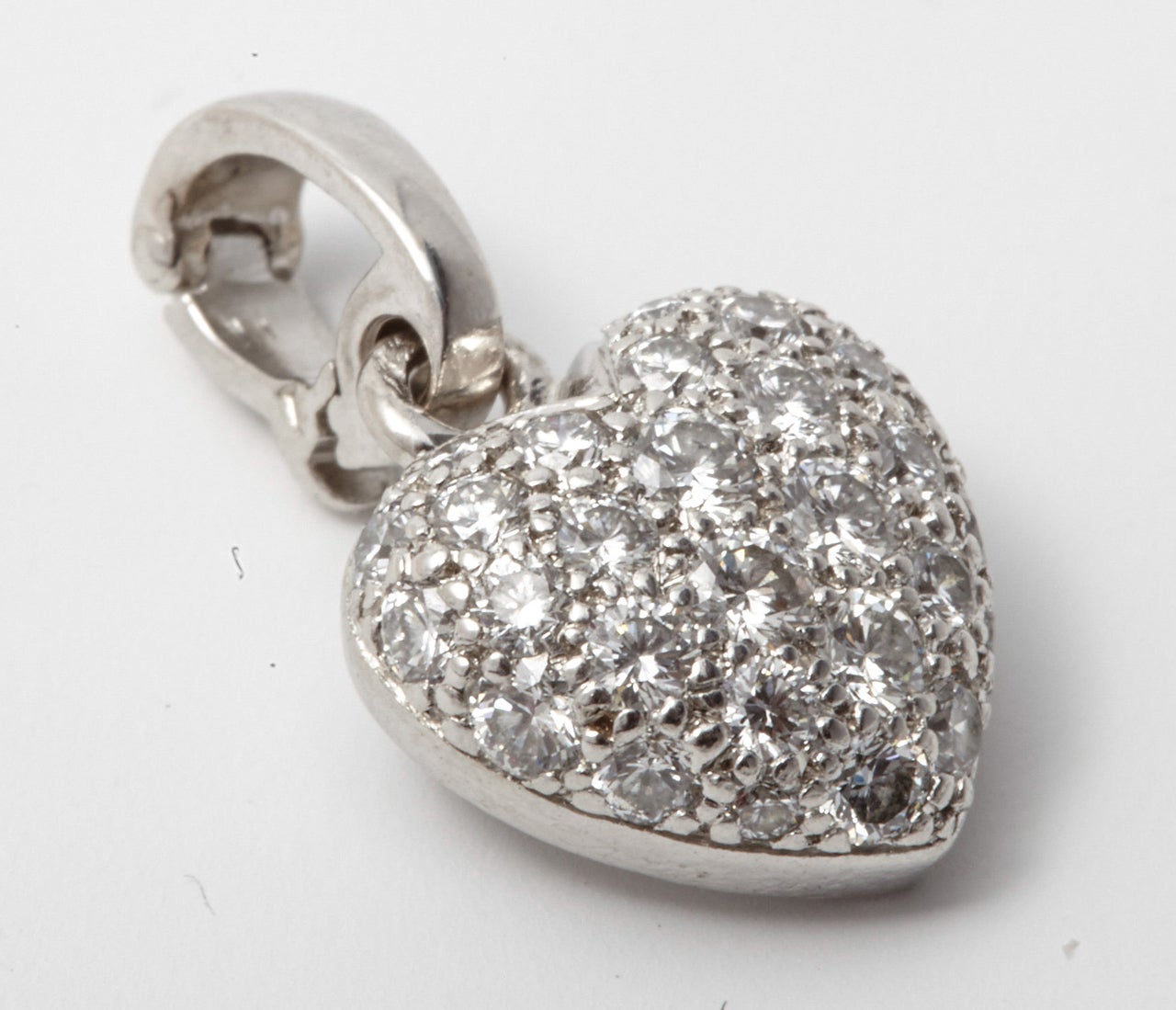 A  modern 18kt white gold heart shaped pendant pavé set with brilliant cut diamonds weighing approximately 0.30 cts, engraved Cartier and ND9124.

All of our prices exclude VAT.
