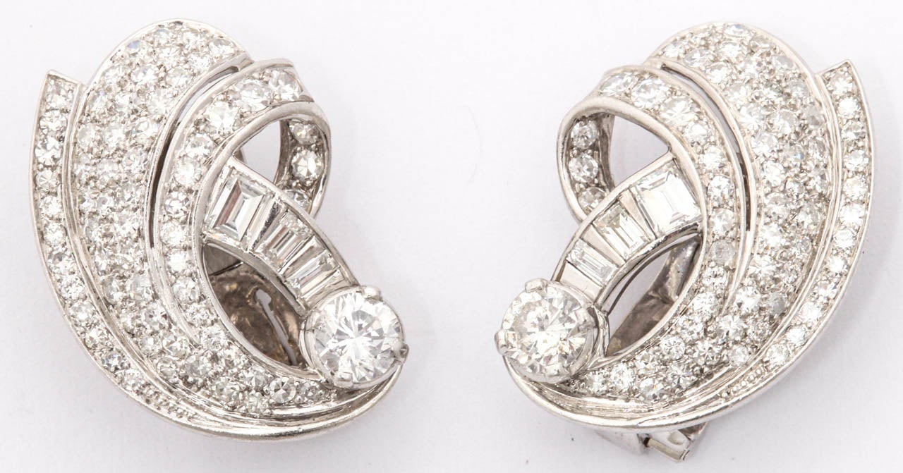 Platinum And Diamond Retro clip on earrings they shrimp up on your ears with mixed baguette cut and round full cut diamonds total weight approximately 4 carats