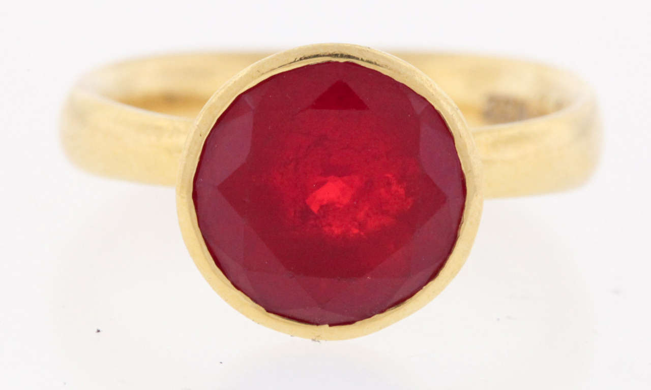 22K gold and deep orange faceted fire opal is set in a martini-style mounting by goldsmith Devta Doolan, who works in high karat gold, 22K usually.  This ring is an extraordinarily good value. The ring measures 3/8