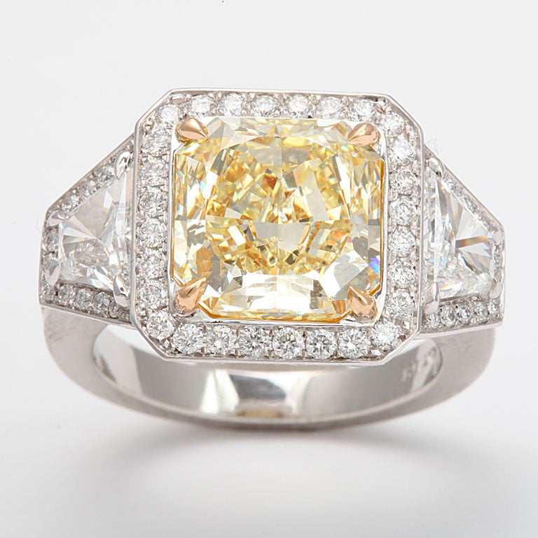 platinum micro pave diamond ring centering a radiant cut diamond 4.40 carats Fancy yellow VVS2  GIA report# 15072959
100 diamonds 1.08 carats
2 trapezoid diamonds 0.94