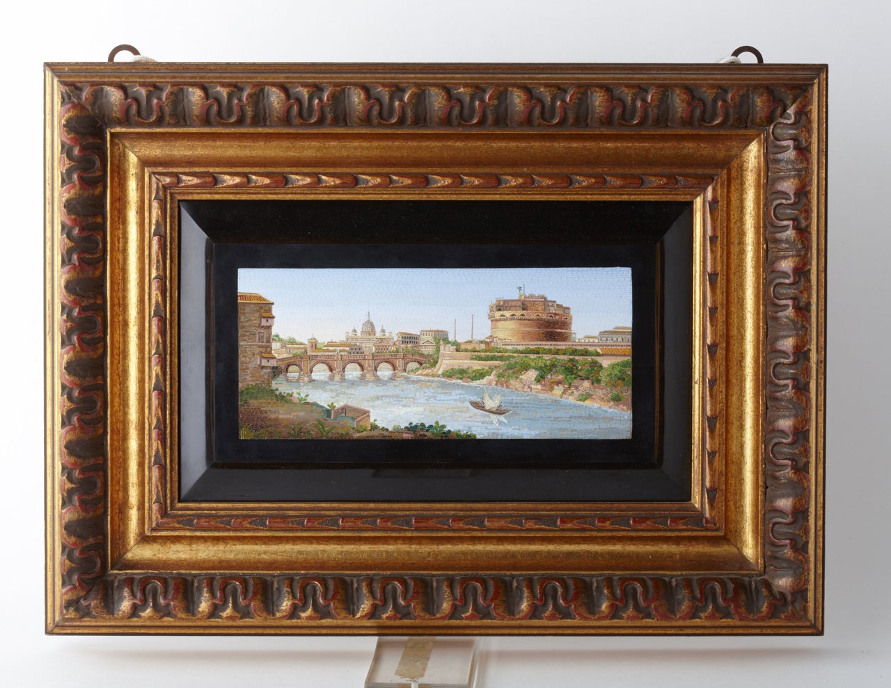 Fantastic micromosaic representing Rome's Castel Sant'Angelo, the Tiber River and the Basilica of Saint Peter on the back.

The micromosaic is in a later wooden frame. 

Roman school, 1820.