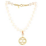 Faux Pearl Strand with Gold Tone Pendant by Chanel.