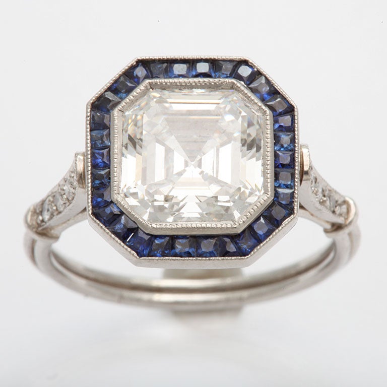 A stunning Ascher cut 3.13 ct VS 1 F diamond is surrounded by sapphires and set in platinum. It comes with a GIA certificate