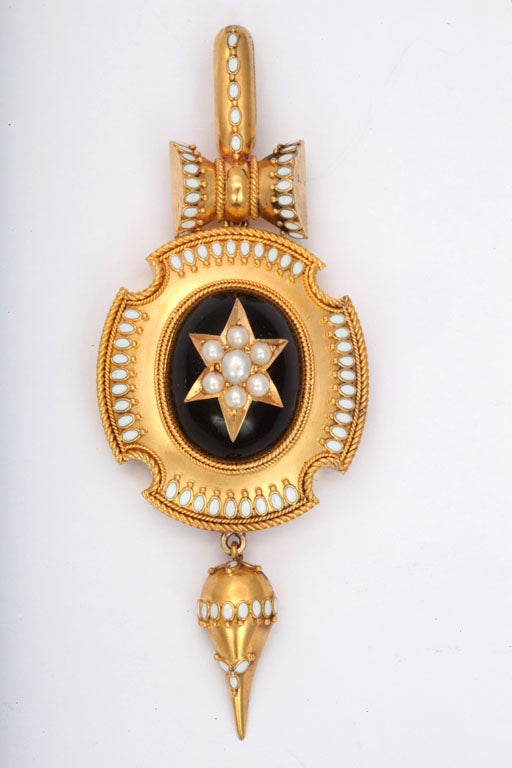 Striking and beautifully different are thoughts that come to mind when you see this pendant. The gold is warm, 15kt and rich. It enhances the white of the pearls and accents of white enamel. The enameling is perfect. The bale and suspended drop are