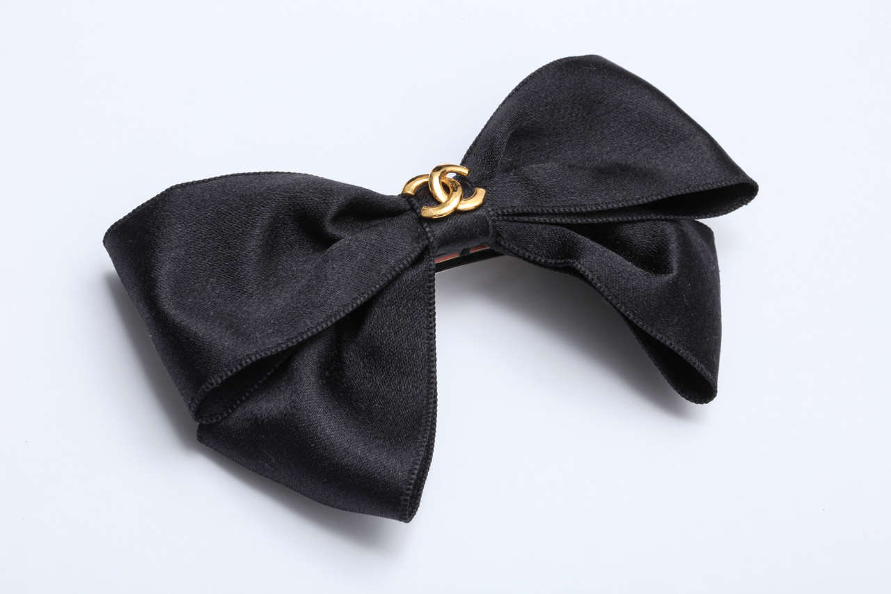 Very rare Chanel black satin hair clip with bow and iconic CC logos.