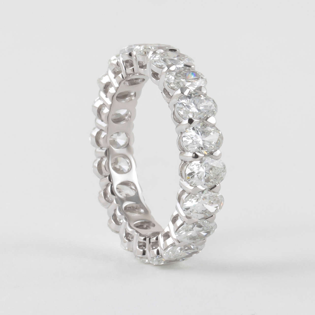 A unique diamond eternity band out of the many that we carry.

4.86 carats of oval shaped diamonds. 

G color Vs clarity

18k white gold

Ring size adjustable, currently a size  6.5
