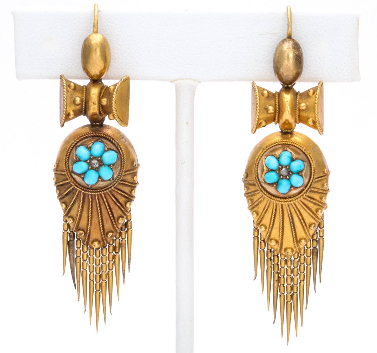 The elements of Victoriana  make their appearance in this pair of substantial chandelier earrings. Articulated fringe gives movement to the jewels dressing them in feminine grace. Interest abounds with the addition of applied gold wire and small