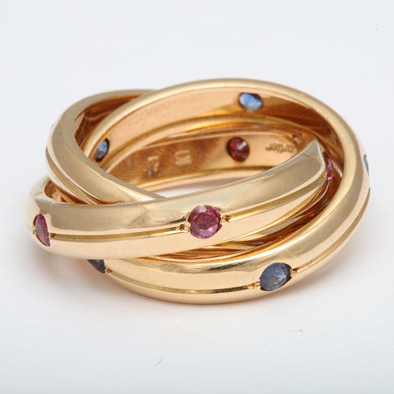 18kt yellow gold triple rolling ring band embellished with high quality rubies sapphires and diamonds
