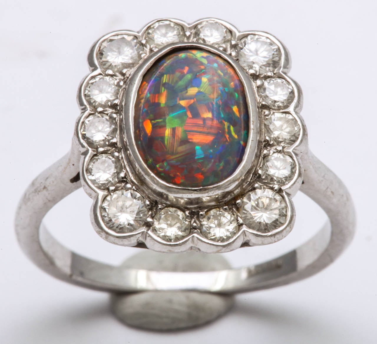 Sumptuous  high mounted Black Opal Ring with full cut clean white Diamonds.  18kt white gold with all stones bezel & prong set. Makes a wonderful pinky ring or 4th finger depending on how you want to feature the Ring.