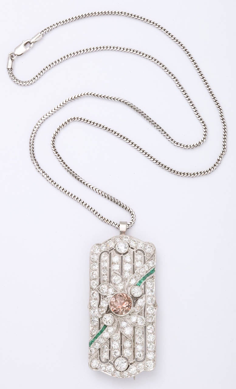 Art Deco Platinum Pin set with full cut Diamonds & with a center design in Morganite & channel cut Emerald Baguettes