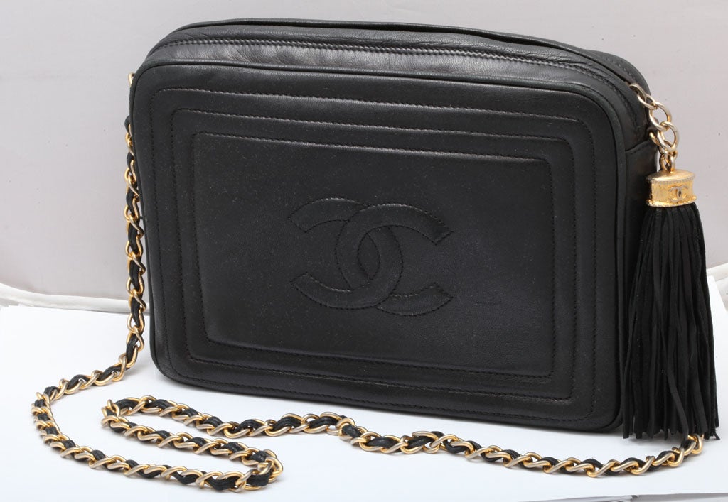 Vintage Chanel black shoulder bag with tassel. Chain length 38 inches.