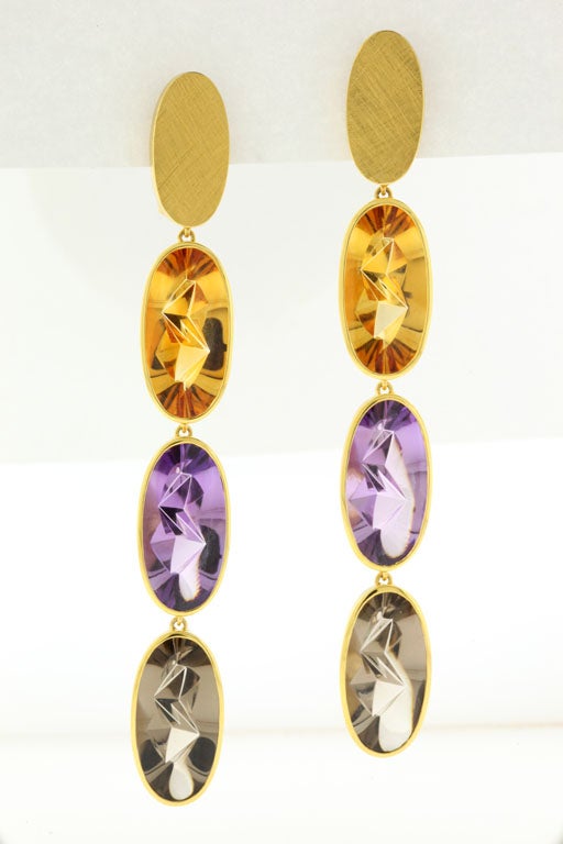 Jutta Munsteiner's dramatically brilliant gemstone earrings -- 18K gold, citrine, amethyst and smoky quartz -- are ingeniously cut by her husband and gem sculptor Tom Munsteiner, from the famed Munsteiner Studio in Germany,  to shimmer and glow in