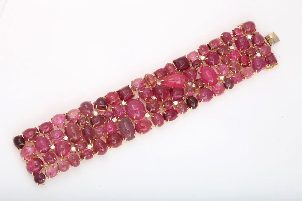 18k yellow gold articulated mount set with 78 cabochon pink tourmalines 215 carats<br />
18 diamonds 1.01