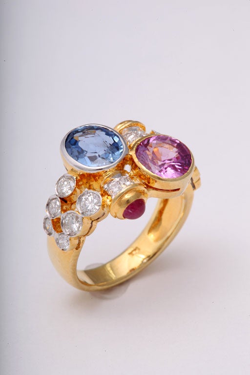 Pink and Blue Sapphire Gold Crossover Ring with Diamonds and Ruby Accents In Excellent Condition In Miami Beach, FL