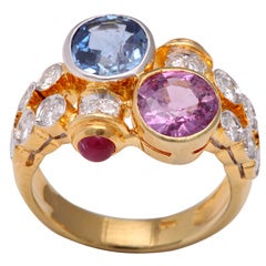 Pink and Blue Sapphire Gold Crossover Ring with Diamonds and Ruby Accents