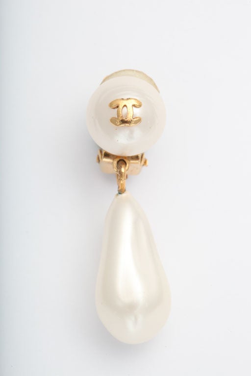 Chanel mini earrings with dangling pearls and CCs.