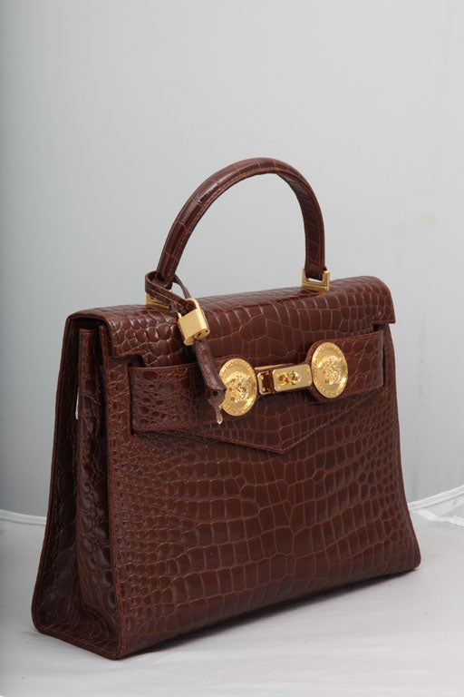 Very rare Gianni Versace Couture croc embossed bag with gold medusas.